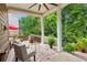 Covered patio with outdoor seating surrounded by lush greenery, perfect for relaxing outdoors at 2434 Soft Maple St, Atlanta, GA 30360