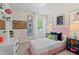 Cozy bedroom with pink bed, decorative wall art, and natural light from the window at 320 Navigator Ln, Mcdonough, GA 30253