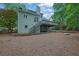 View of the home's backyard showing the deck, stairs, and lush greenery with a bridge on a creek at 4047 Watkins Glen Dr, Woodstock, GA 30189