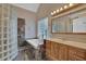 Bathroom showcasing a bathtub, a glass block shower, and a wooden vanity with ample storage at 4047 Watkins Glen Dr, Woodstock, GA 30189