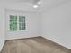 Clean, carpeted bedroom with natural light from the large window at 4047 Watkins Glen Dr, Woodstock, GA 30189