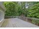 Large deck overlooks lush greenery, perfect for outdoor relaxation at 4047 Watkins Glen Dr, Woodstock, GA 30189