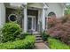 Front Entrance with elegant stonework, arched window, and meticulously maintained landscaping at 4047 Watkins Glen Dr, Woodstock, GA 30189