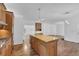 Kitchen island with light-colored wood cabinets and countertop overlooking the living and dining areas at 4047 Watkins Glen Dr, Woodstock, GA 30189