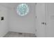 Bright laundry room with tile flooring, a round decorative window, and storage space at 4047 Watkins Glen Dr, Woodstock, GA 30189