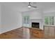 Spacious living room with hardwood floors, a fireplace, and an adjacent sunroom with large windows at 4047 Watkins Glen Dr, Woodstock, GA 30189