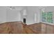Bright living room featuring hardwood floors, a fireplace, and natural light from multiple windows at 4047 Watkins Glen Dr, Woodstock, GA 30189