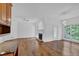 Open-concept living room with hardwood floors, a fireplace, a ceiling fan, and access to the backyard at 4047 Watkins Glen Dr, Woodstock, GA 30189