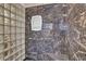 Shower featuring marble-style tile, glass block wall, and a built-in seat at 4047 Watkins Glen Dr, Woodstock, GA 30189