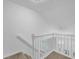 Bright staircase with white railing and carpeted steps leading upstairs at 4047 Watkins Glen Dr, Woodstock, GA 30189
