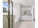 Bathroom featuring a soaking tub and a double vanity with marble countertops at 4060 Andover Cir, Mcdonough, GA 30252