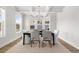 Elegant dining room with coffered ceiling, large windows, and contemporary chandelier at 4060 Andover Cir, Mcdonough, GA 30252
