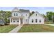 Beautifully built two-story home with gray siding, black roof, and a cozy front porch at 4060 Andover Cir, Mcdonough, GA 30252
