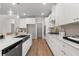 Bright, modern kitchen with stainless appliances, island with barstool seating, and walk-in pantry at 4060 Andover Cir, Mcdonough, GA 30252