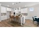 Spacious kitchen features a large island with seating, modern appliances, and stylish pendant lighting at 4060 Andover Cir, Mcdonough, GA 30252