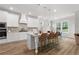Bright kitchen features a large island, pendant lighting, stainless appliances, and wood-look floors at 4060 Andover Cir, Mcdonough, GA 30252