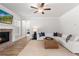 Bright living room features a fireplace, ceiling fan, and comfortable sectional sofa at 4060 Andover Cir, Mcdonough, GA 30252