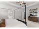 A main bedroom features a four-poster bed and an ensuite bathroom at 4060 Andover Cir, Mcdonough, GA 30252