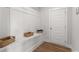 Well-organized mudroom with bench seating, storage baskets, and a convenient entry door at 4060 Andover Cir, Mcdonough, GA 30252