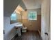A bathroom with a pedestal sink, toilet, and window at 5460 Huron Dr, Morrow, GA 30260