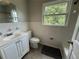 Bathroom featuring a white vanity, tile floors, and a window above the toilet at 5460 Huron Dr, Morrow, GA 30260