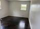 Cozy bedroom with hardwood floors, freshly painted walls, and a window at 5460 Huron Dr, Morrow, GA 30260
