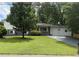 Charming single-story home with a lush green lawn and a paved driveway at 5460 Huron Dr, Morrow, GA 30260