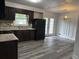 Updated kitchen with dark wood cabinets, modern appliances, and vinyl floors at 5460 Huron Dr, Morrow, GA 30260