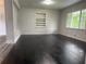 Living room featuring dark hardwood floors, built-in shelving and abundant natural light at 5460 Huron Dr, Morrow, GA 30260