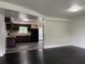 Open concept view of the living room into the updated kitchen with hardwood floors at 5460 Huron Dr, Morrow, GA 30260