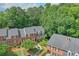 Aerial view of brick townhomes with well-maintained landscaping and mature trees at 701 Dunwoody Chace, Atlanta, GA 30328