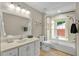 Well-lit bathroom features a shower-tub combination and a large vanity with ample storage space at 701 Dunwoody Chace, Atlanta, GA 30328