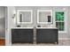 Bright bathroom featuring double vanities, decorative tile floors, and backlit mirrors at 701 Dunwoody Chace, Atlanta, GA 30328
