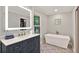 Elegant bathroom with floating tub, decorative tile floor, and sleek vanity at 701 Dunwoody Chace, Atlanta, GA 30328