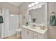 Bright bathroom features a shower-tub combination, white vanity, and ample lighting for a clean and fresh feel at 701 Dunwoody Chace, Atlanta, GA 30328