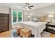 Comfortable bedroom with plush king bed, ceiling fan, and windows with serene nature views at 701 Dunwoody Chace, Atlanta, GA 30328