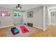 Bright exercise room features hardwood floors, built in shelving, and natural light perfect for a home gym at 701 Dunwoody Chace, Atlanta, GA 30328