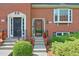 Close-up of a red brick townhome showcasing front door details and manicured landscaping at 701 Dunwoody Chace, Atlanta, GA 30328