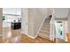 Open foyer leading to a staircase, kitchen, and front entrance, showcasing hardwood floors and neutral walls at 701 Dunwoody Chace, Atlanta, GA 30328