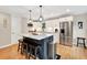 Open-concept kitchen with an island, stainless steel appliances, and sleek white cabinetry at 701 Dunwoody Chace, Atlanta, GA 30328