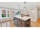 Bright kitchen features a stylish island with white countertop, storage, and elegant pendant lighting at 701 Dunwoody Chace, Atlanta, GA 30328