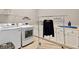 Convenient laundry room features modern appliances, counter space, and storage for efficient chore management at 701 Dunwoody Chace, Atlanta, GA 30328