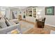 Spacious living room with hardwood floors, fireplace, and built-in shelving with tasteful decor at 701 Dunwoody Chace, Atlanta, GA 30328