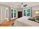 Comfortable main bedroom with plush king bed, ceiling fan, and French doors to deck with serene views at 701 Dunwoody Chace, Atlanta, GA 30328