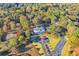 Aerial shot of a stately home on a beautifully landscaped lot surrounded by colorful trees at 1445 Hillside Dr, Grayson, GA 30017