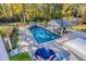 Aerial view of a stunning pool area with a gazebo, waterfall, and lush landscaping, creating a perfect outdoor retreat at 1445 Hillside Dr, Grayson, GA 30017