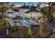 Aerial view of backyard with pool, waterfall, and outdoor dining area perfect for entertaining at 1445 Hillside Dr, Grayson, GA 30017