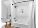Bright bathroom featuring a shower-tub combo with white subway tile and a built-in shelf at 1445 Hillside Dr, Grayson, GA 30017