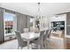 Elegant dining room with gray walls, large windows, and a modern chandelier at 1445 Hillside Dr, Grayson, GA 30017