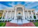 Front exterior of a stately white home with prominent columns, manicured lawn, and a welcoming entrance at 1445 Hillside Dr, Grayson, GA 30017